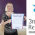 GDA's Chief Executive Tressa Burke holds the Glasgow Hate Crime Pledge next to a logo that reads' 3rd Party Reporting