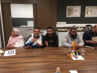 Group of members sit at a table in the Kelvinhall