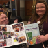 two GDA members smile and hold copies of a GDA report 'Rights Now' with colourful illustrations on the front and a collage of photos on the inner pages