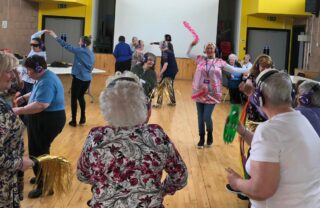 Members dance at a 'silent' disco in a community hall
