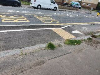 Badly planned spaces for people infrastructure with a tactile board not on the pavement, but on a cycle lane.
