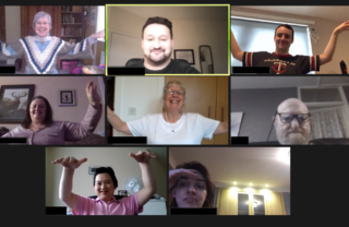 Picture of people holding their arms in the arm in a Tai Chi pose.