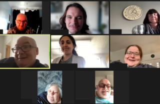 a group of 8 GDA members meet online via Zoom. People are smiling and talking. The workshop is taking place during a sunny day with daylight visible in the rooms of attendees.