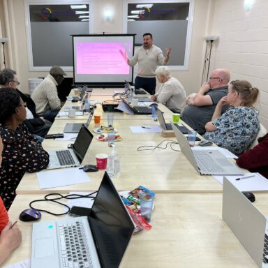 Jonathan stands at the front of the room, delivering digital coaching to a room of GDA members. Jonathan stands at the front of the room, delivering digital coaching to a room of GDA members.